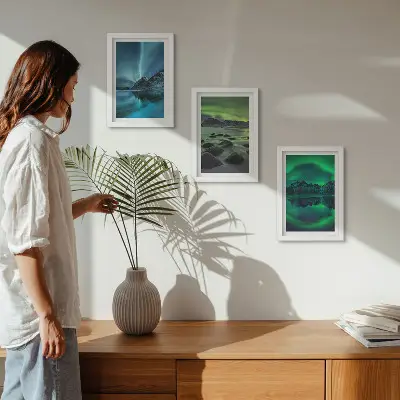 Photo frame wall with a winter landscape featuring northern lights and mountains