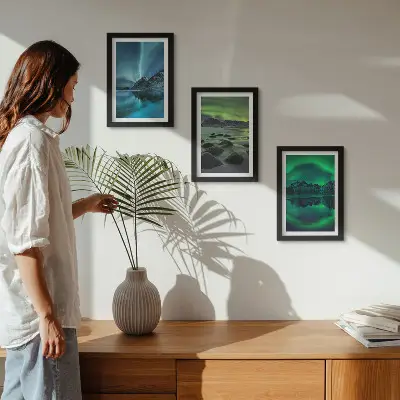 Photo frame wall with a winter landscape featuring northern lights and mountains