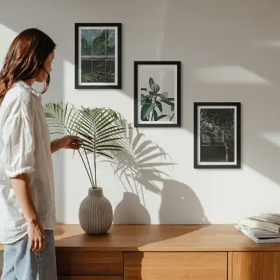 Green leaves on the window and plants inside framed triptych