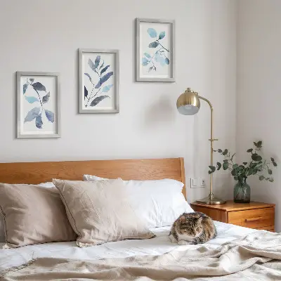 Framed triptych blue leaves on a light background in watercolor style