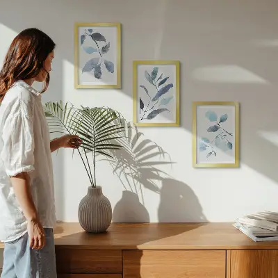 Framed triptych blue leaves on a light background in watercolor style