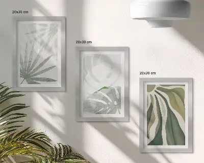 Photo frame wall with green and gray plant leaves
