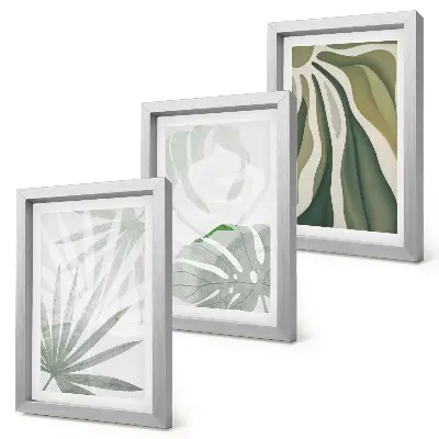 Photo frame wall with green and gray plant leaves