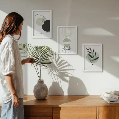 Photo frame wall gallery with abstract shapes and green plant motifs