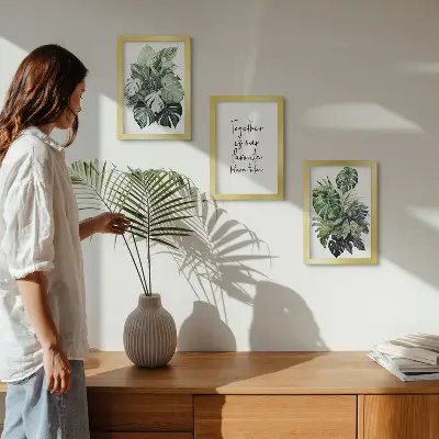Photo frame wall with tropical green leaf prints and decorative text