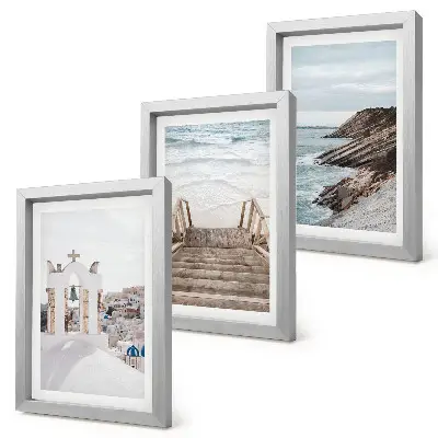 Photo frame wall featuring views of the sea and Santorini architecture against the sky