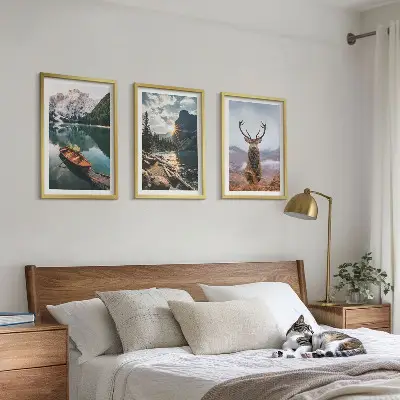 Three-piece wall art set featuring a mountain lake, boat, and deer at sunset