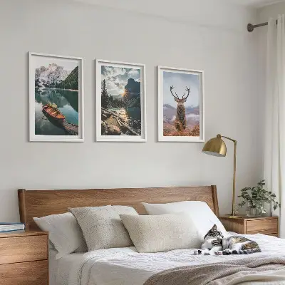 Three-piece wall art set featuring a mountain lake, boat, and deer at sunset