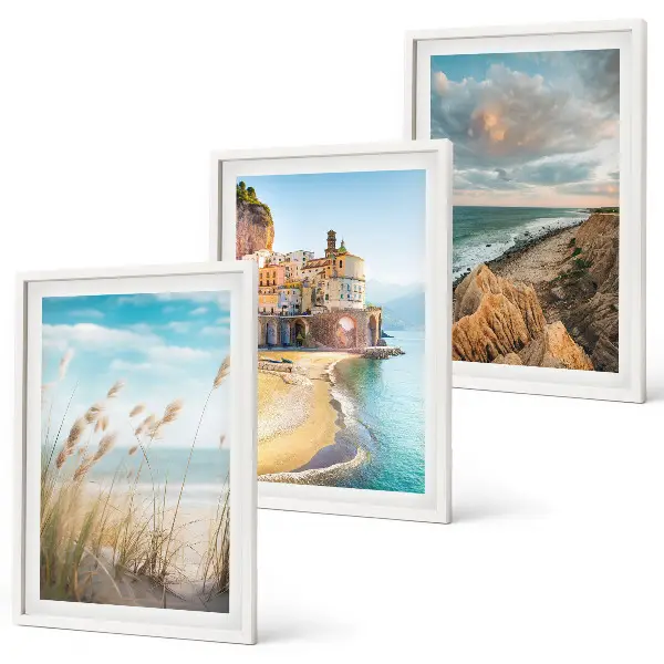 Set of 3 framed wall art pieces featuring landscape scenes of beaches cliffs and cities