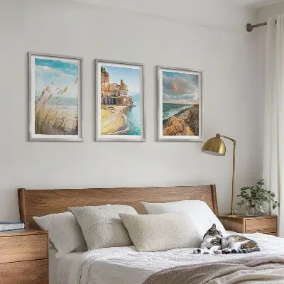 Set of 3 framed wall art pieces featuring landscape scenes of beaches cliffs and cities