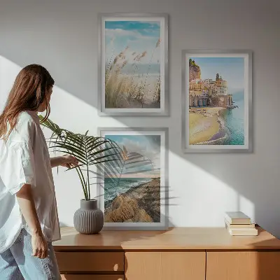 Set of 3 framed wall art pieces featuring landscape scenes of beaches cliffs and cities