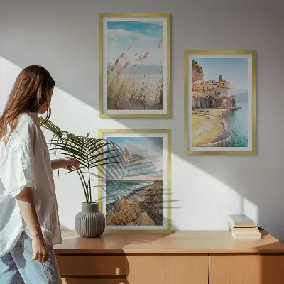 Set of 3 framed wall art pieces featuring landscape scenes of beaches cliffs and cities