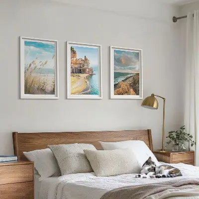 Set of 3 framed wall art pieces featuring landscape scenes of beaches cliffs and cities