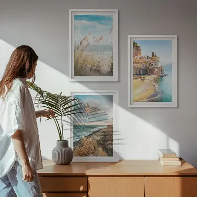 Set of 3 framed wall art pieces featuring landscape scenes of beaches cliffs and cities