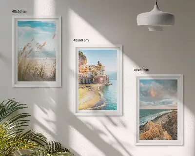 Set of 3 framed wall art pieces featuring landscape scenes of beaches cliffs and cities