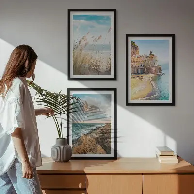 Set of 3 framed wall art pieces featuring landscape scenes of beaches cliffs and cities