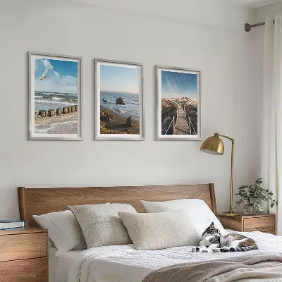 Set of 3 framed wall art pieces featuring a beach with waves, sky, and a pier walk