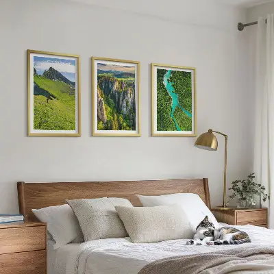 Three-piece wall art set featuring green mountains and river rocks