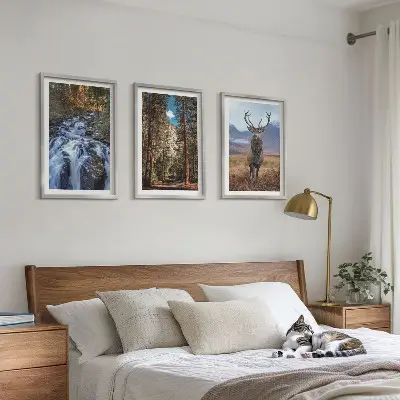 Three-piece wall art set featuring a waterfall in a mountain forest with deer and nature scenery