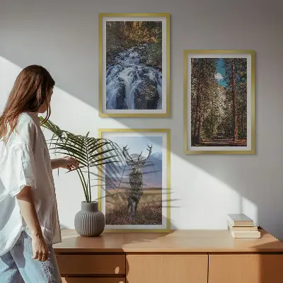 Three-piece wall art set featuring a waterfall in a mountain forest with deer and nature scenery