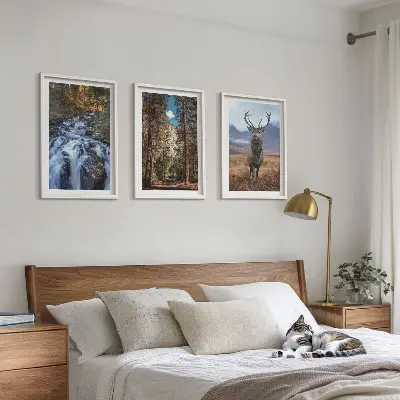 Three-piece wall art set featuring a waterfall in a mountain forest with deer and nature scenery