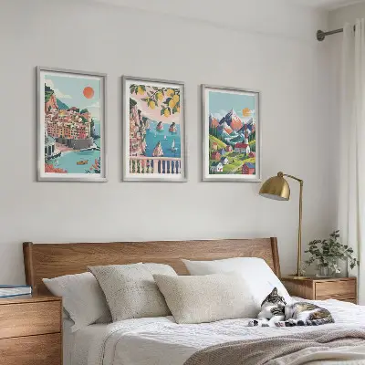 Set of 3 framed wall art pieces with colorful mountains and cities