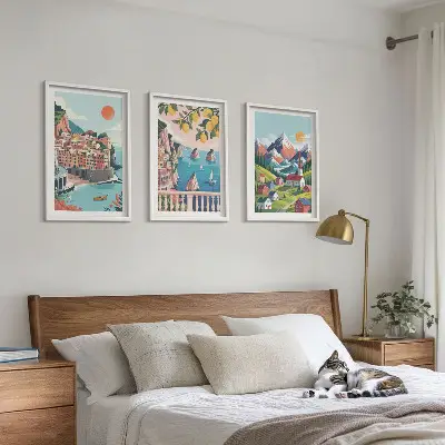 Set of 3 framed wall art pieces with colorful mountains and cities