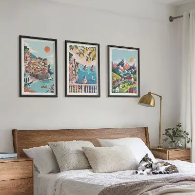Set of 3 framed wall art pieces with colorful mountains and cities