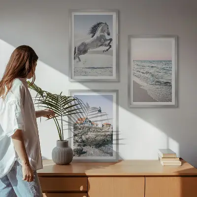 Wall art set featuring horses on a beach with a lighthouse and waves