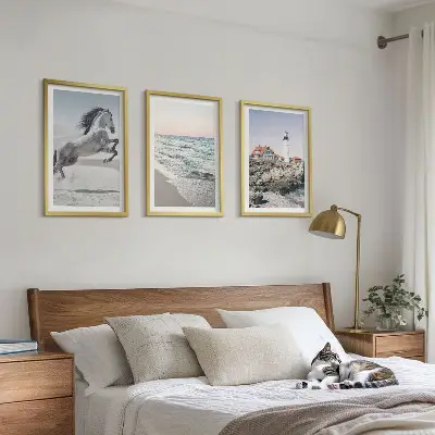 Wall art set featuring horses on a beach with a lighthouse and waves