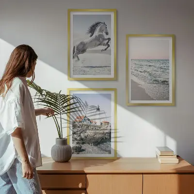 Wall art set featuring horses on a beach with a lighthouse and waves