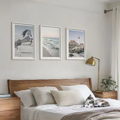Wall art set featuring horses on a beach with a lighthouse and waves