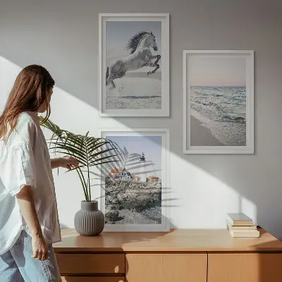 Wall art set featuring horses on a beach with a lighthouse and waves