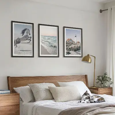 Wall art set featuring horses on a beach with a lighthouse and waves