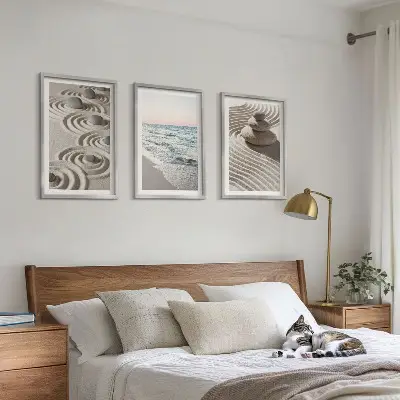 Set of 3 framed wall art pieces featuring waves, sand, water, and beach stones