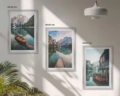 Set of 3 framed wall art pieces featuring a lake, mountains, boat, and cottage