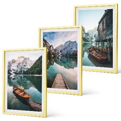 Set of 3 framed wall art pieces featuring a lake, mountains, boat, and cottage