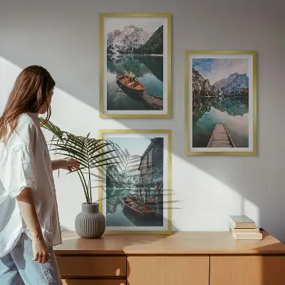 Set of 3 framed wall art pieces featuring a lake, mountains, boat, and cottage