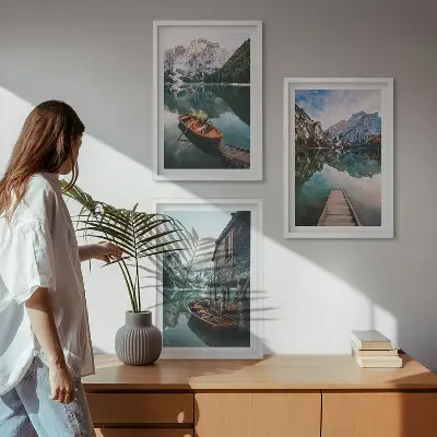 Set of 3 framed wall art pieces featuring a lake, mountains, boat, and cottage