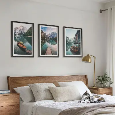 Set of 3 framed wall art pieces featuring a lake, mountains, boat, and cottage