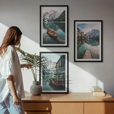 Set of 3 framed wall art pieces featuring a lake, mountains, boat, and cottage