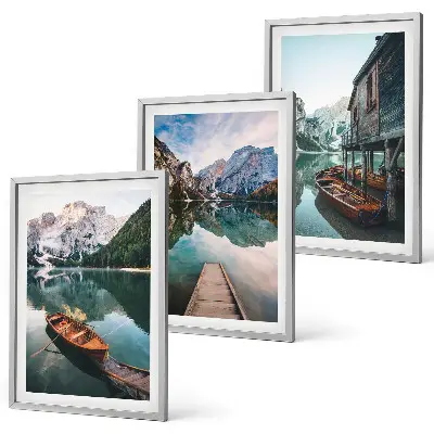 Set of 3 framed wall art pieces featuring a lake, mountains, boat, and cottage