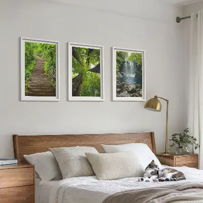 Set of 3 framed wall art pieces featuring a path through a forest with a waterfall and lush vegetation