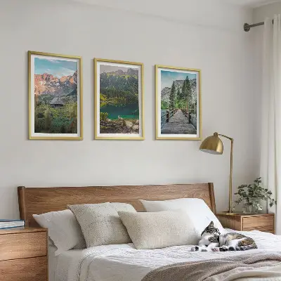 Three-piece mountain landscape wall art featuring a lake and bridge