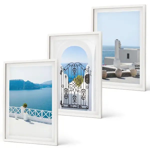 Set of 3 framed wall art pieces featuring white buildings by the sea in Greece