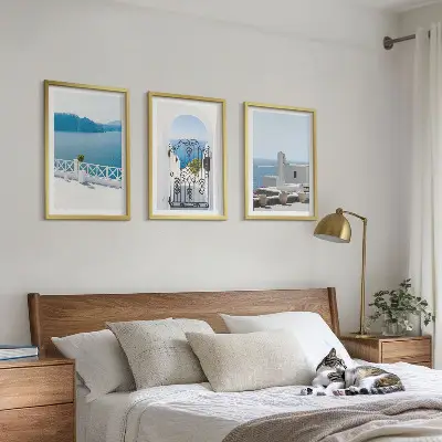 Set of 3 framed wall art pieces featuring white buildings by the sea in Greece