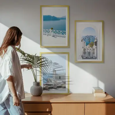 Set of 3 framed wall art pieces featuring white buildings by the sea in Greece