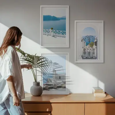 Set of 3 framed wall art pieces featuring white buildings by the sea in Greece