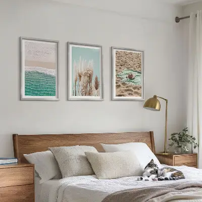 Set of 3 framed wall art pieces featuring a beach with waves, grass, and a hat