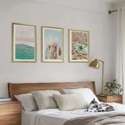 Set of 3 framed wall art pieces featuring a beach with waves, grass, and a hat